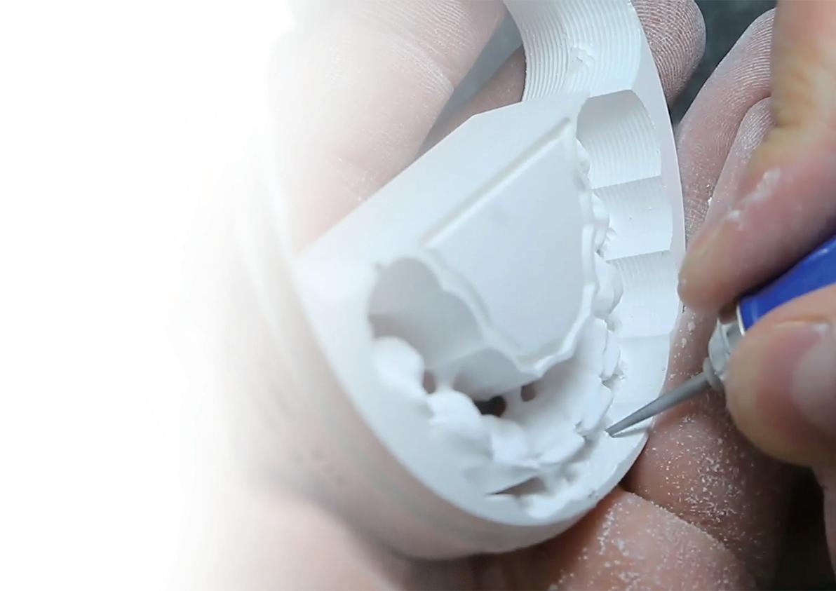 Technician finishing a milled zirconia arch